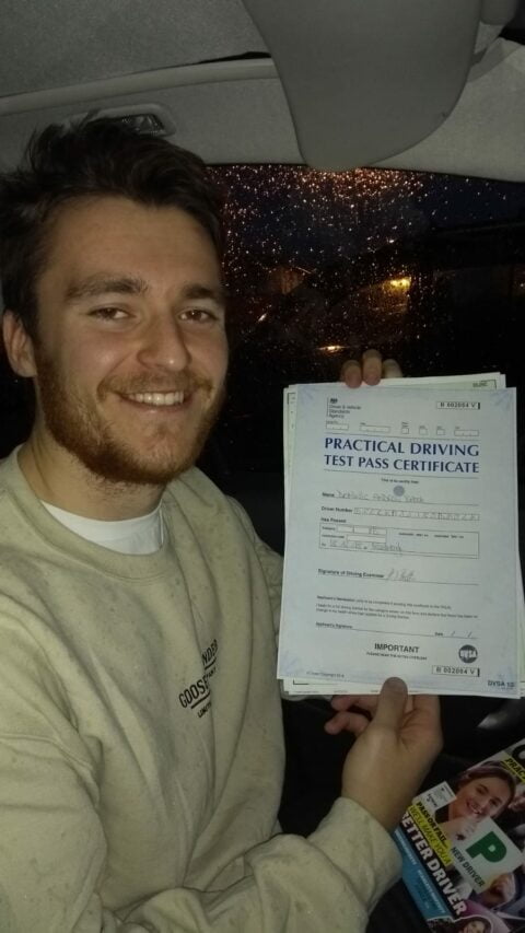 Roadcraft student holding driving test pass certificate
