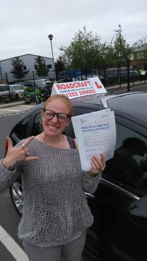 Roadcraft student holding driving test pass certificate