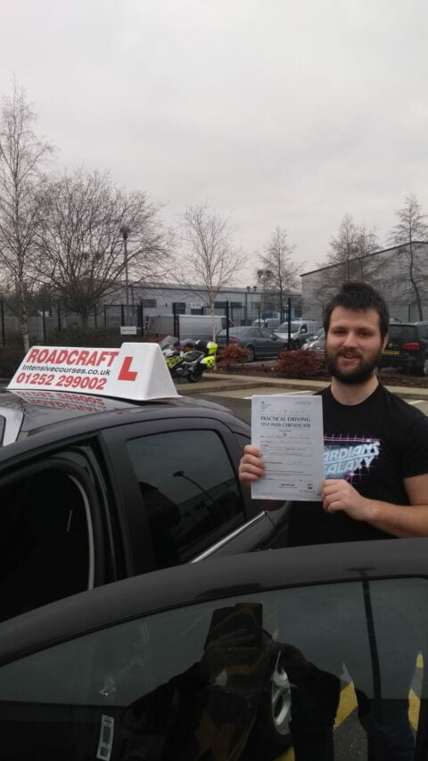 Roadcraft student holding driving test pass certificate