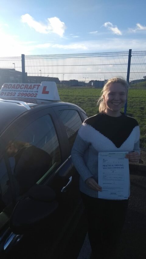 Roadcraft student holding driving test pass certificate