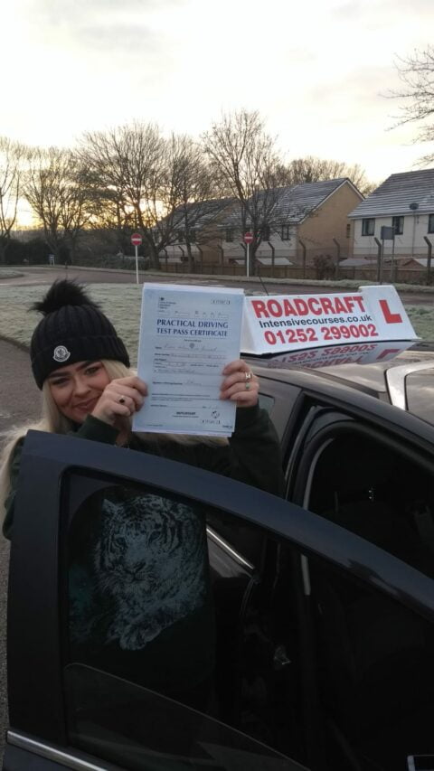 Roadcraft student holding driving test pass certificate
