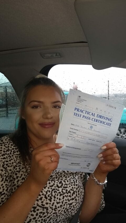 Roadcraft student holding driving test pass certificate