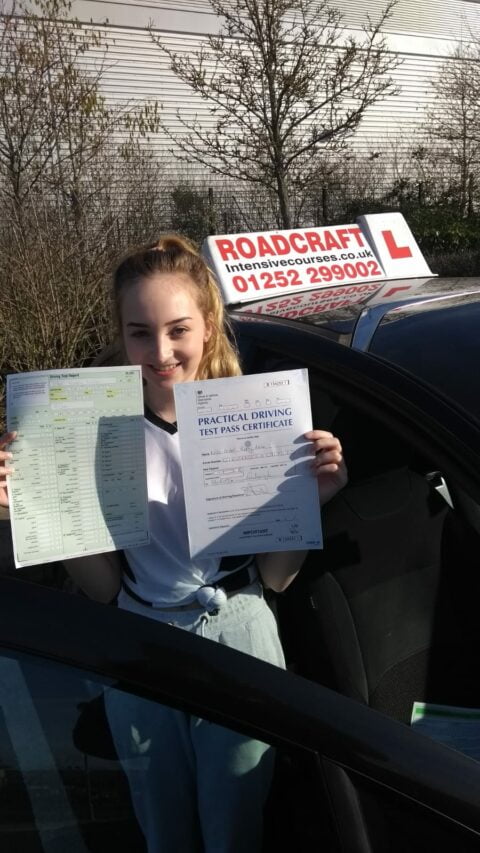 Roadcraft student holding driving test pass certificate