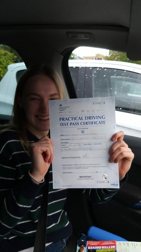 Roadcraft student holding driving test pass certificate