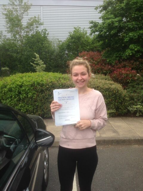 Roadcraft student holding driving test pass certificate