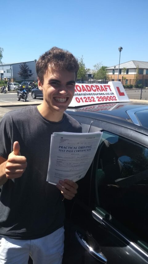 Roadcraft student holding driving test pass certificate