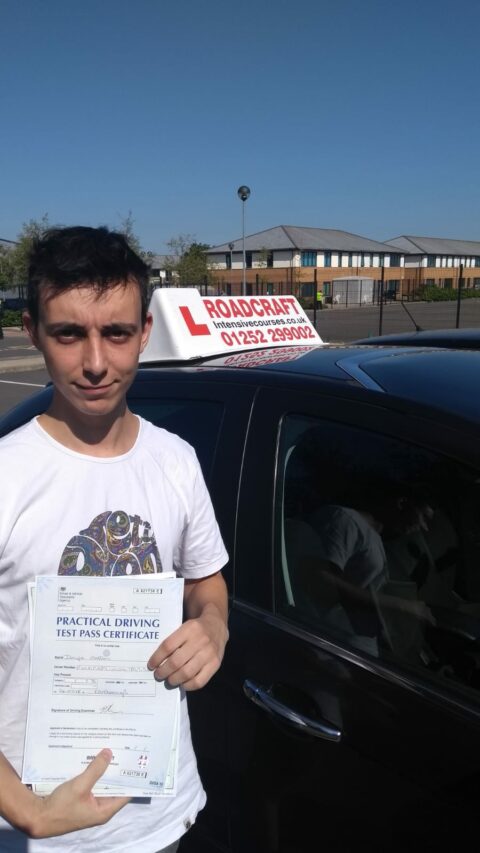 Roadcraft student holding driving test pass certificate