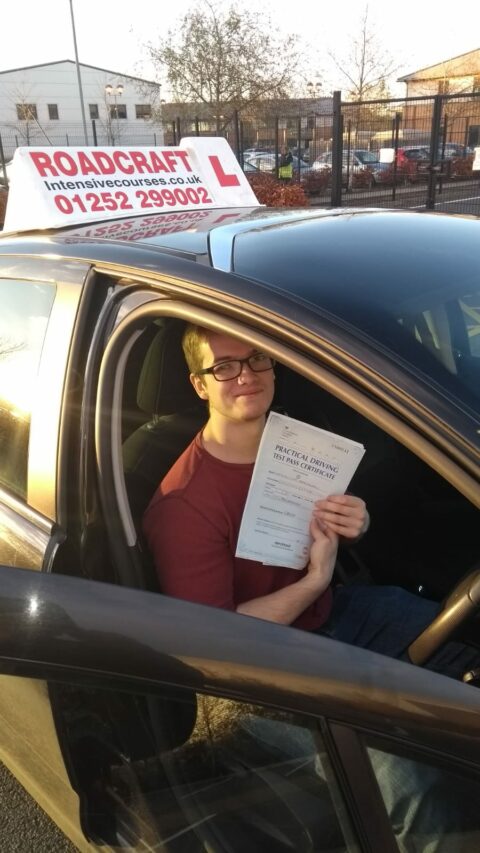 Roadcraft student holding driving test pass certificate