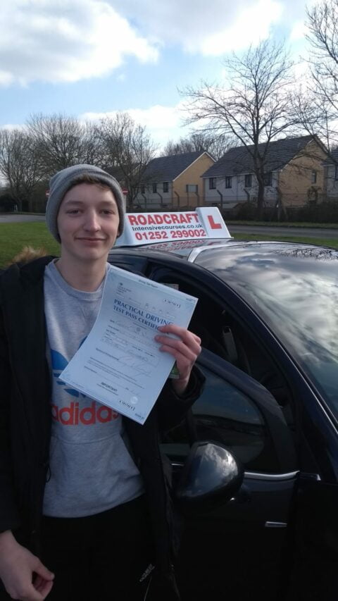 Roadcraft student holding driving test pass certificate
