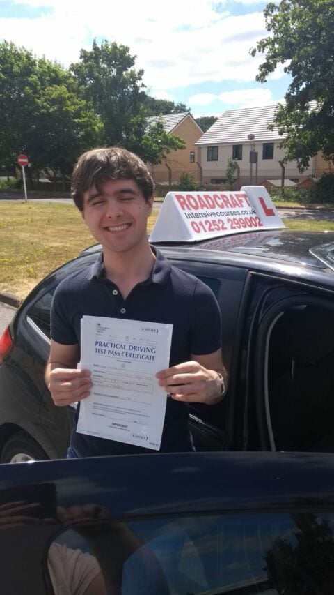 Roadcraft student holding driving test pass certificate