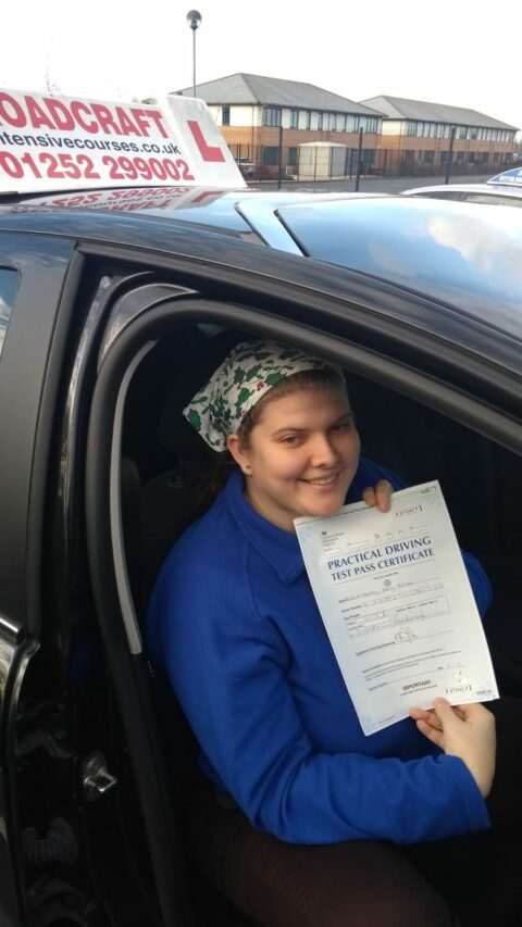 Roadcraft student holding driving test pass certificate