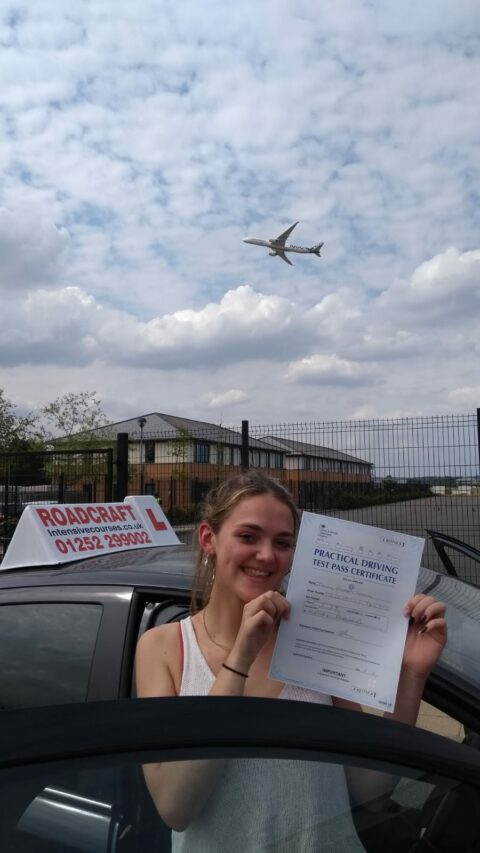 Roadcraft student holding driving test pass certificate