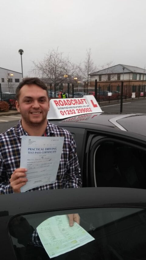 Roadcraft student holding driving test pass certificate