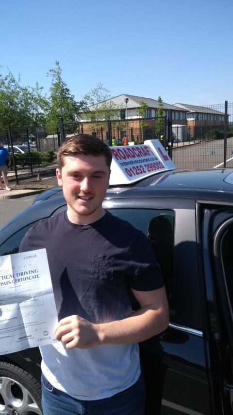 Roadcraft student holding driving test pass certificate