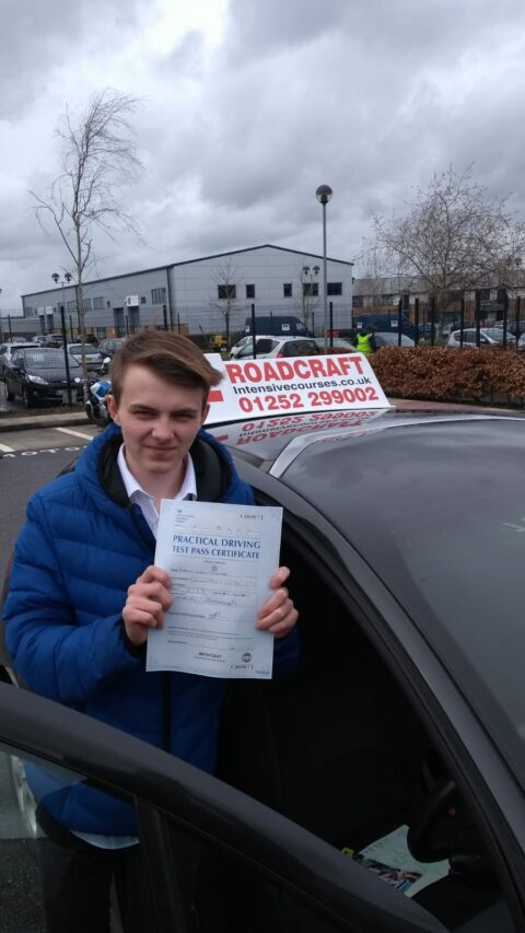 Roadcraft student holding driving test pass certificate