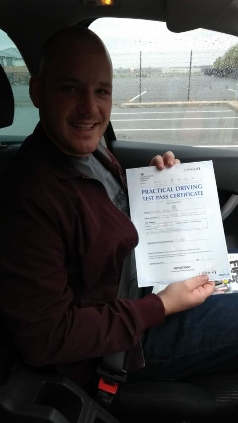 Roadcraft student holding driving test pass certificate