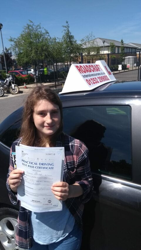 Roadcraft student holding driving test pass certificate