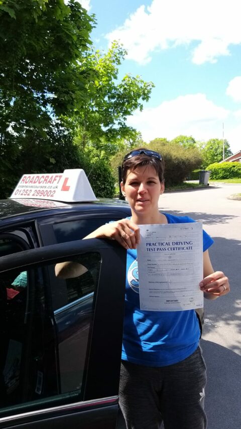 Roadcraft student holding driving test pass certificate