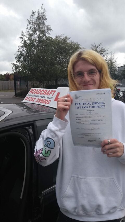 Roadcraft student holding driving test pass certificate
