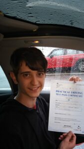 Roadcraft student holding driving test pass certificate