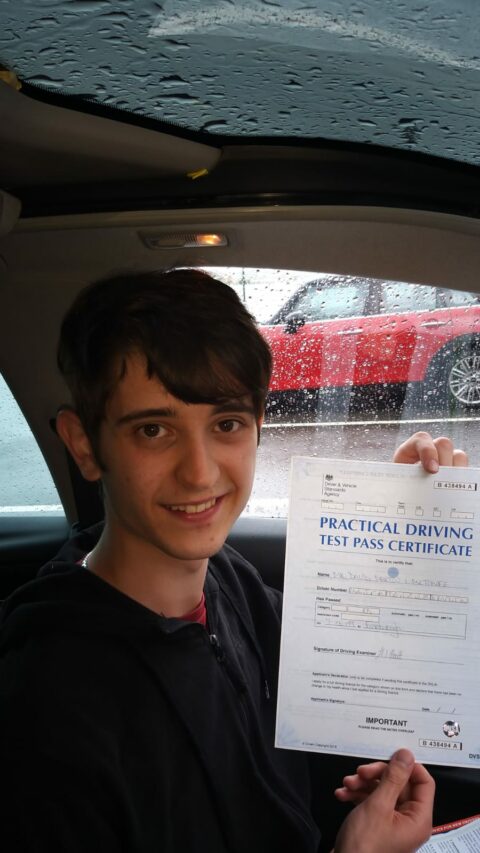 Roadcraft student holding driving test pass certificate