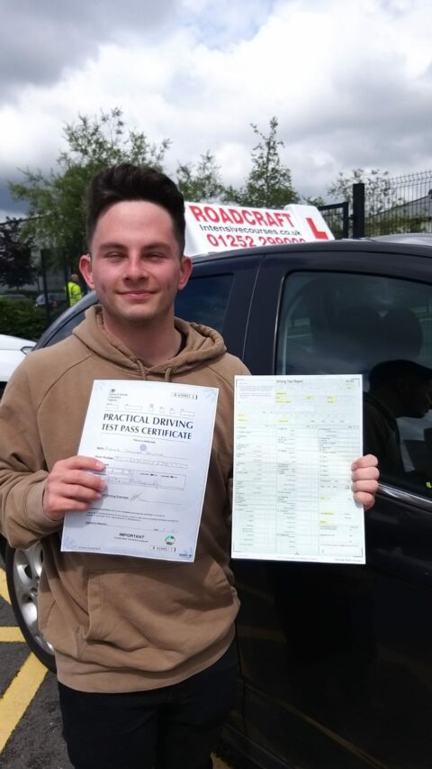Roadcraft student holding driving test pass certificate