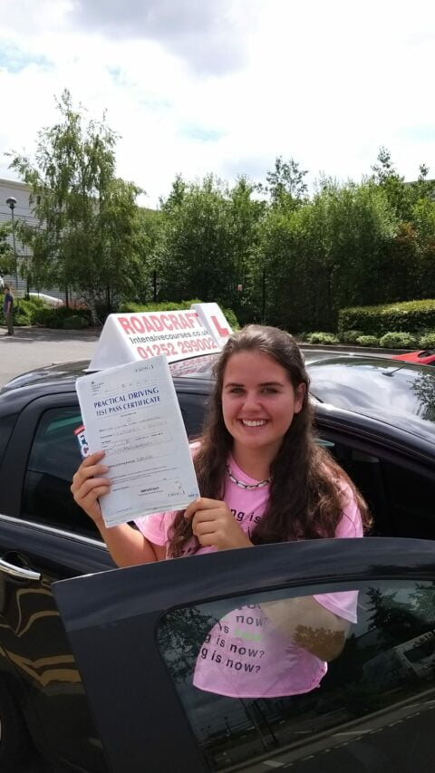 Roadcraft student holding driving test pass certificate
