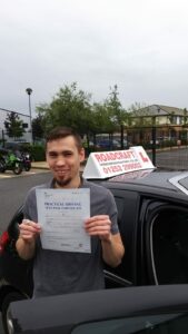 Roadcraft student holding driving test pass certificate