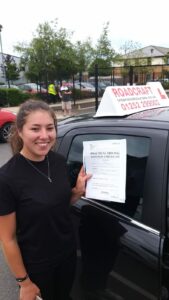 Roadcraft student holding driving test pass certificate