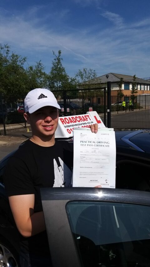 Roadcraft student holding driving test pass certificate