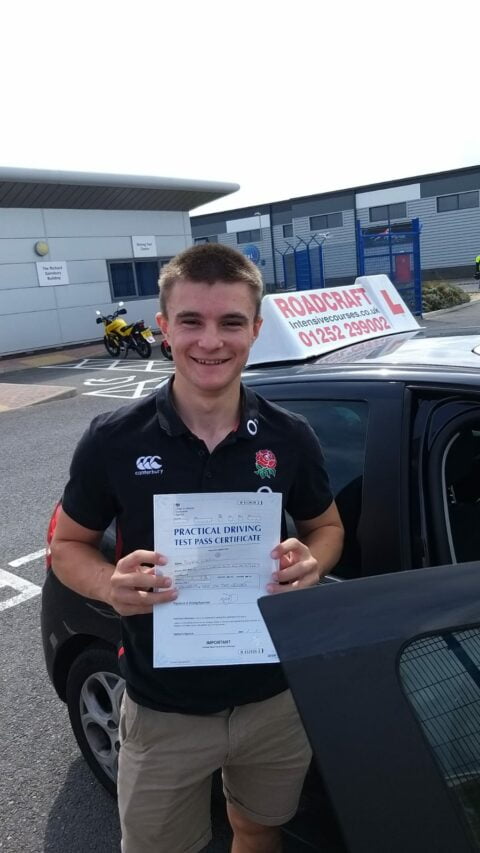 Roadcraft student holding driving test pass certificate