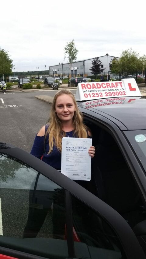 Roadcraft student holding driving test pass certificate