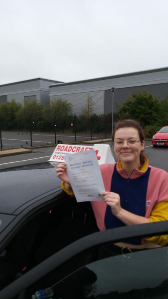 Roadcraft student holding driving test pass certificate