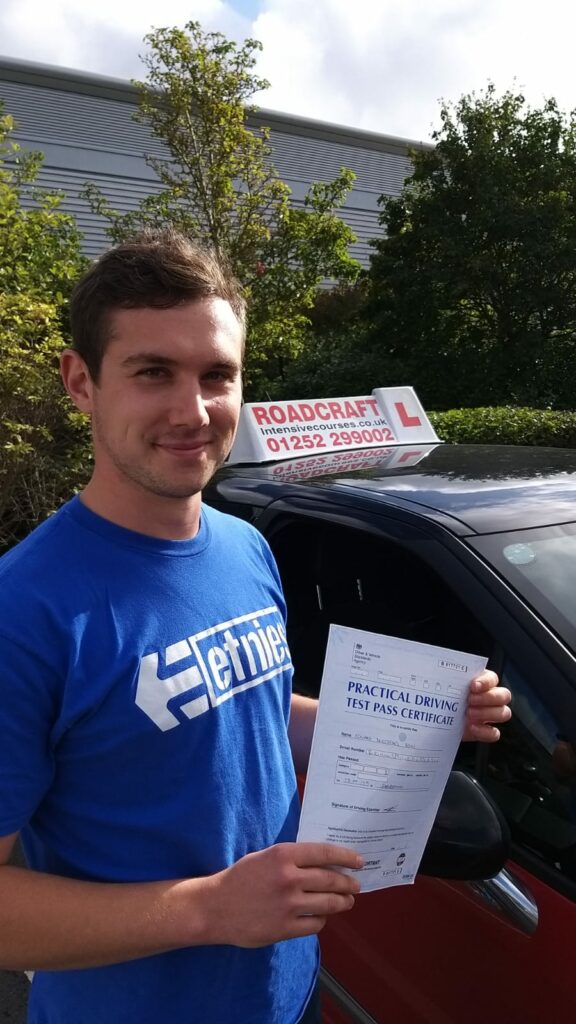 Roadcraft student holding driving test pass certificate