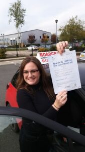 Roadcraft student holding driving test pass certificate