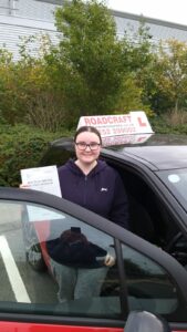 Roadcraft student holding driving test pass certificate