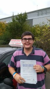 Roadcraft student holding driving test pass certificate