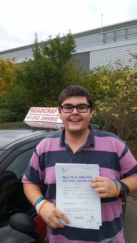 Roadcraft student holding driving test pass certificate