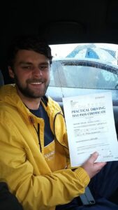 Roadcraft student holding driving test pass certificate