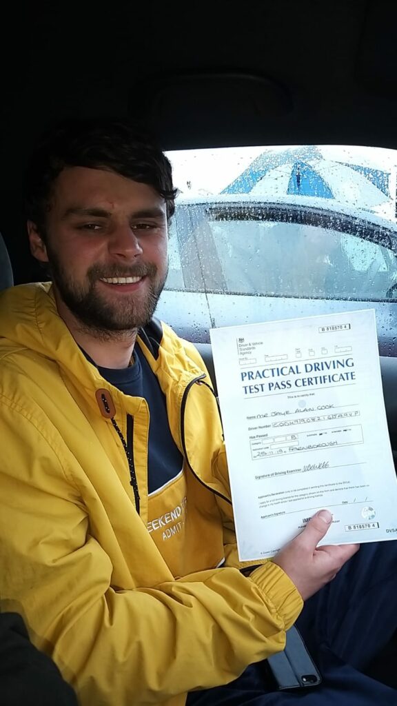 Roadcraft student holding driving test pass certificate