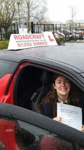 Roadcraft student holding driving test pass certificate