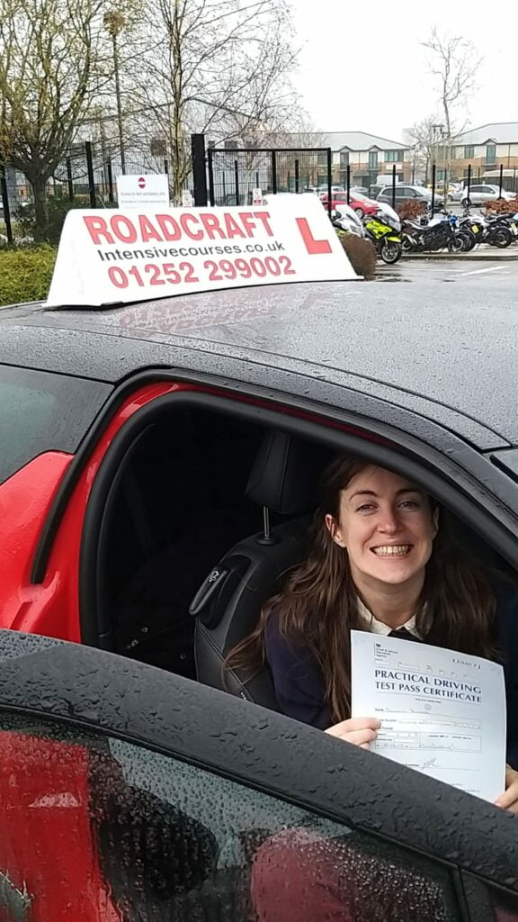 Roadcraft student holding driving test pass certificate