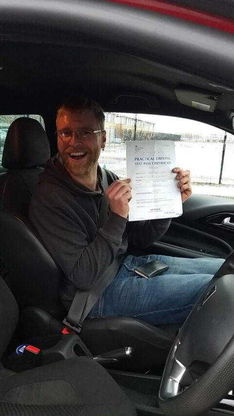 Roadcraft student holding driving test pass certificate