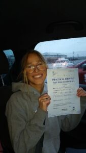 Roadcraft student holding driving test pass certificate