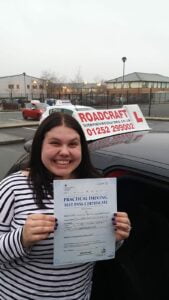 Roadcraft student holding driving test pass certificate