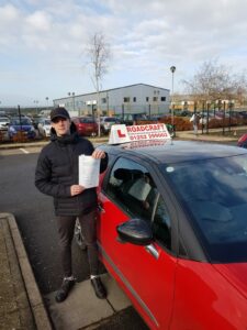 Roadcraft student holding driving test pass certificate