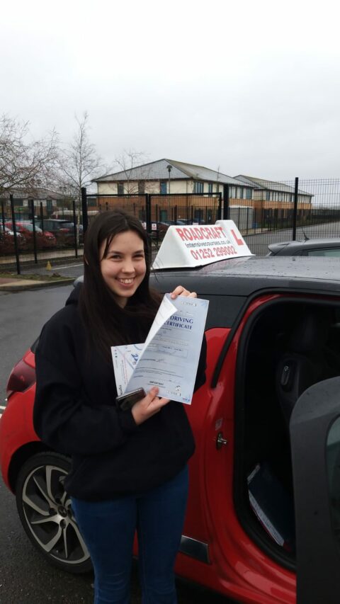 Roadcraft student holding driving test pass certificate