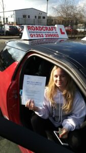 Roadcraft student holding driving test pass certificate