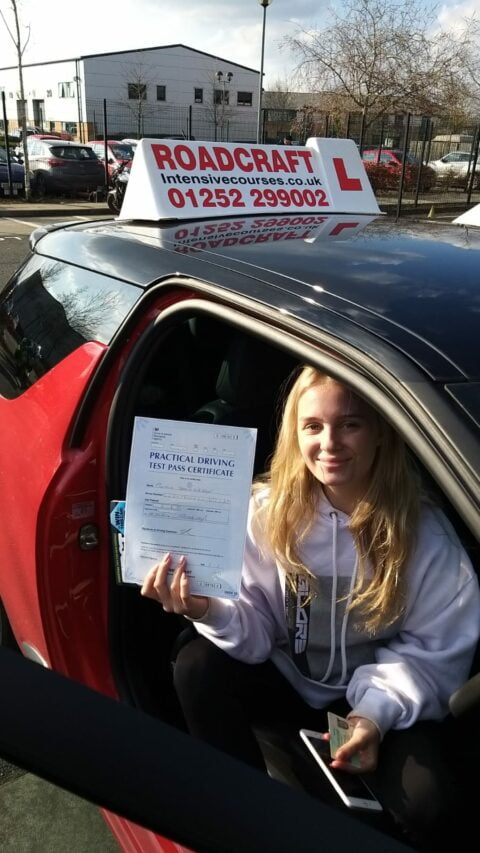Roadcraft student holding driving test pass certificate