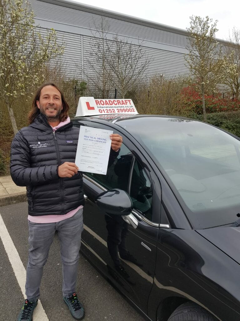 Roadcraft student holding driving test pass certificate